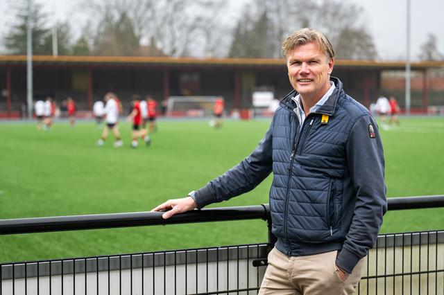 Henk Jan Jensema, de voorzitter van Be Quick 1887. Op de achtergrond voetbalt het bewuste Onder-19-team van de club, dat uit competitie is genomen.