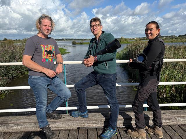 Jochem Duijts (l) en de natuurfotografen Kor Bakker en Cynthia Hoogkamer zijn speciaal naar De Onlanden gekomen om otters te spotten.
